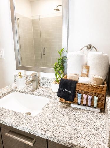 a bathroom with a sink and towels on a counter at Ember Sky Penthouse in Atlanta
