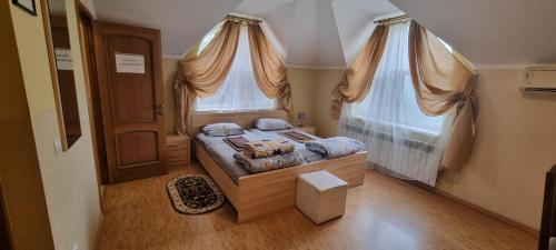 a small bedroom with a bed with a window at VILLA VERA in Berehove