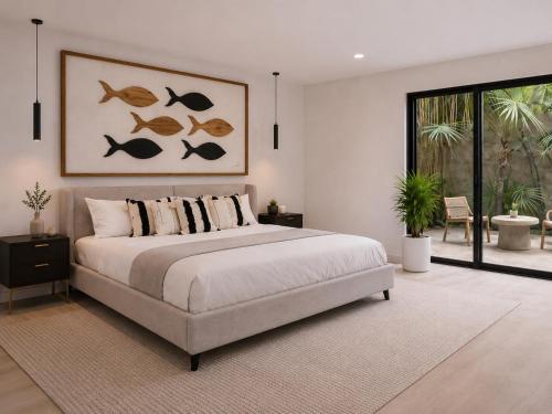 a bedroom with a large bed and a large window at Garden Atelier - Private Cenote & Steps from the Beach in Tulum