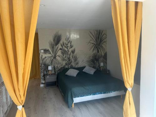 a bedroom with a bed with yellow curtains at Flassans Gites &Spa in Flassans-sur-Issole