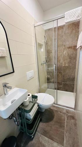 a bathroom with a toilet and a sink and a shower at City Room Filip without window in Poreč