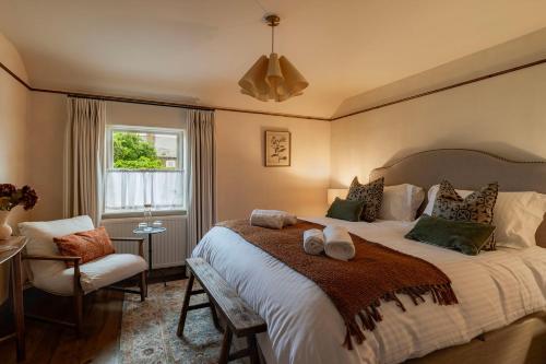 a bedroom with a bed and a chair and a window at The General Tarleton in Knaresborough