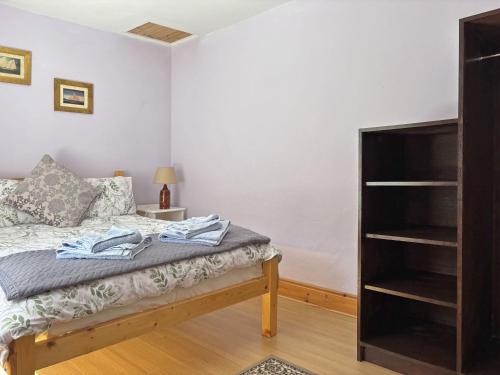 a bedroom with a bed and a book shelf at Cottage 507 - Renvyle in Renvyle