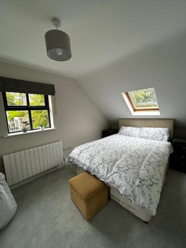 a bedroom with a bed and two windows at Teach na Radharc in Raheen