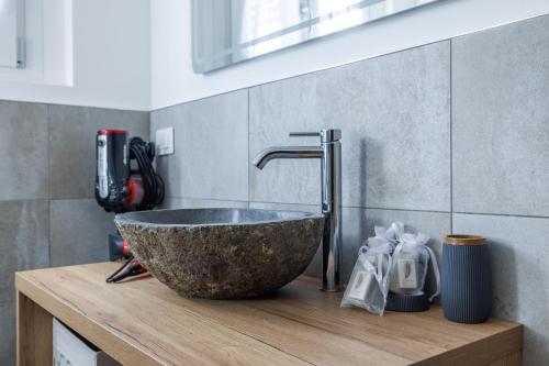 a bathroom with a large stone sink on a wooden counter at CHALET LAURA apricacasevacanze in Aprica