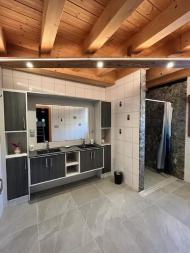 a large kitchen with a sink and a counter at Chalet Heidi in Ventron