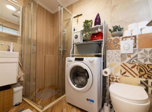 a bathroom with a washing machine and a toilet at Marghareta Nest 2 - TOP Location in Dubrovnik