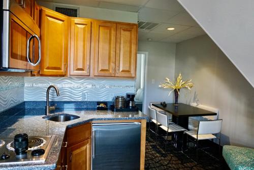 a kitchen with a sink and a counter top at Periwinkle Inn in Cape May