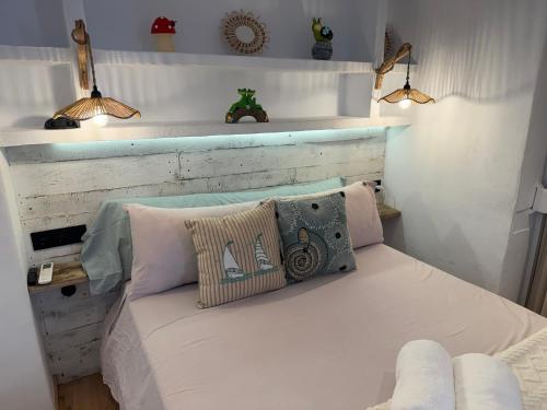 a bedroom with a bed with two pillows on it at Puerto de Jávea in Jávea