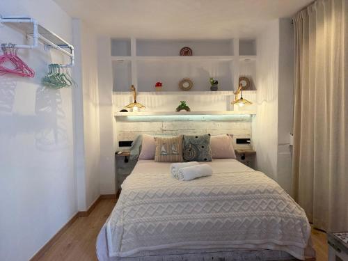 a bedroom with a large white bed in a room at Puerto de Jávea in Jávea