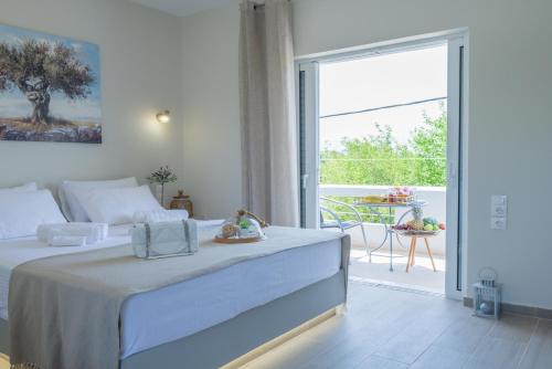 a bedroom with a bed and a balcony with a table at Diana's Houses in Gythio