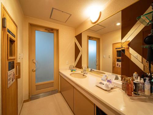 a bathroom with a sink and a mirror at HOTEL WiLL 大高 レジャーホテル in Nagoya