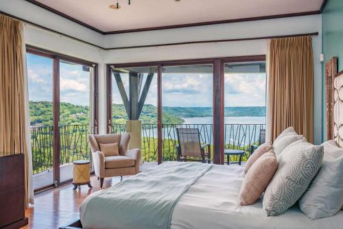 a bedroom with a large bed and a balcony at Las Terrazas 7 Peninsula Papagayo in Nacascolo
