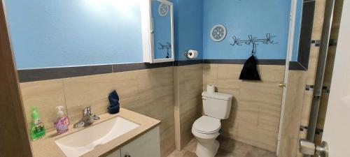 a small bathroom with a toilet and a sink at Great location to explore Houston in Houston