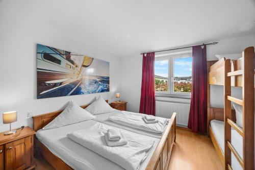 a bedroom with a bed and a large window at Gästehaus am Wasserpark in Rust
