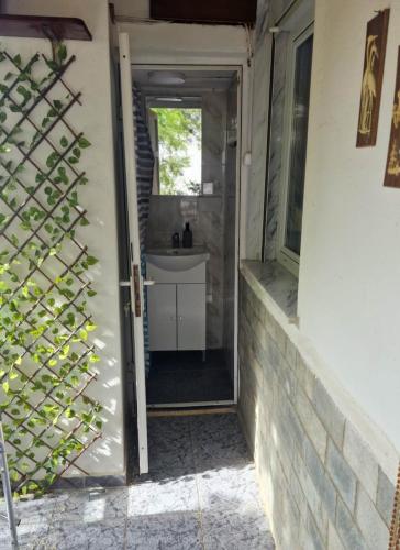 a door leading into a bathroom with a sink at Castle View in Samothraki