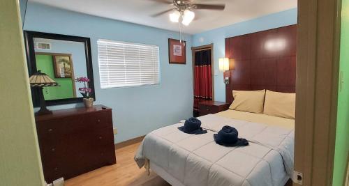 a bedroom with a bed with two hats on it at Great location to explore Houston in Houston