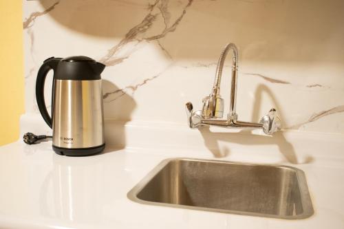 a coffee kettle sitting next to a kitchen sink at Posada Miraflores in Lima