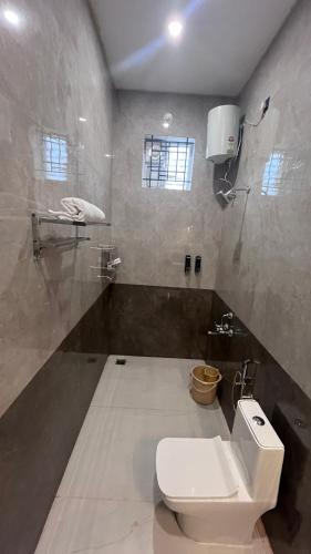 a bathroom with a toilet and a sink at Lumiere Point Yercaud in Yercaud