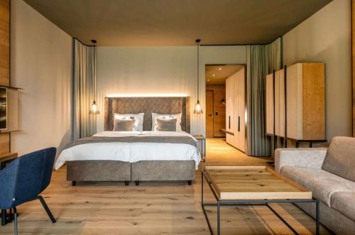 a bedroom with a large bed and a couch at The Elevate Hotel Near Terminal 3 Delhi Airport With- Free Airport Pickup in New Delhi