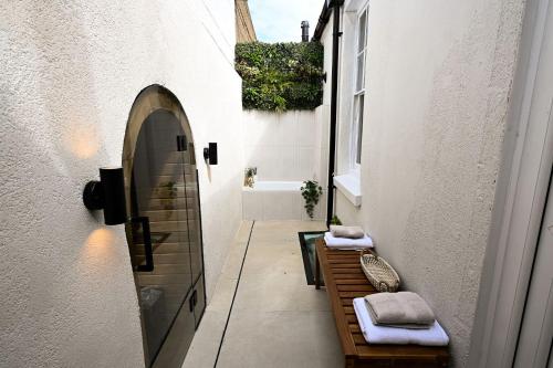 a bathroom with a bench and a bath tub at Kent House in Ramsgate