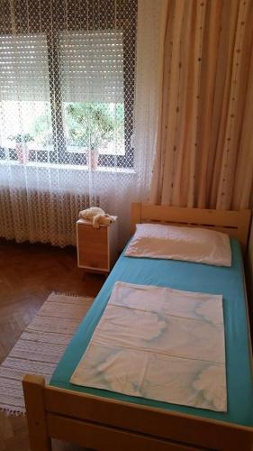 a bedroom with a bed and a window at Apartment Tatjana in Ljubljana