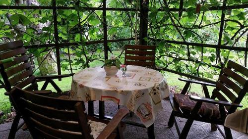 una mesa con sillas y un jarrón con una planta. en Apartment Tatjana, en Liubliana
