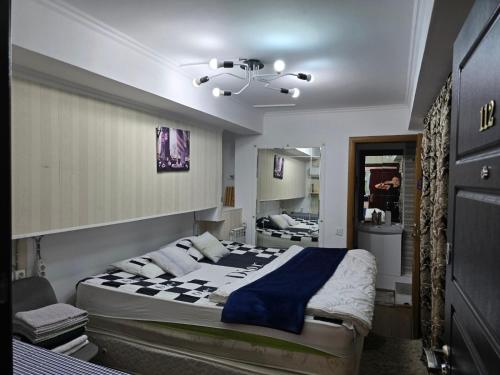 a bedroom with a large bed and a bathroom at La'Mansarda in Chişinău