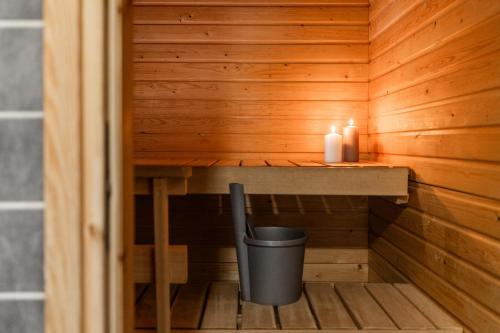 a sauna with a trash can and two candles at Central Studio I by Elys Collection in Rovaniemi