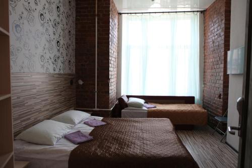 Ein Bett oder Betten in einem Zimmer der Unterkunft Мой отель на Сенной