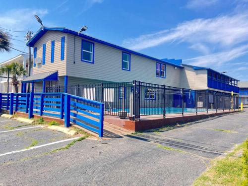 a blue fence in front of a house at CMI Hotel 1935 Myrtle Beach SC in Myrtle Beach