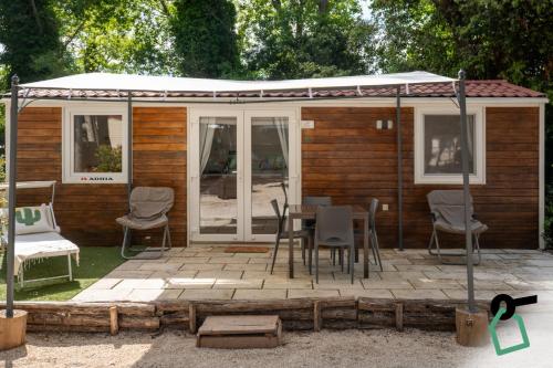 a house with a patio with a table and chairs at Hotiday Otranto Porto in Otranto