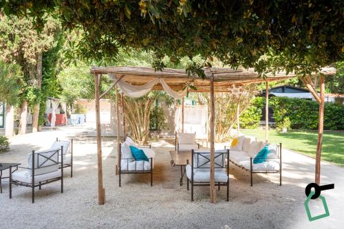 a group of chairs and tables under a gazebo at Hotiday Otranto Porto in Otranto