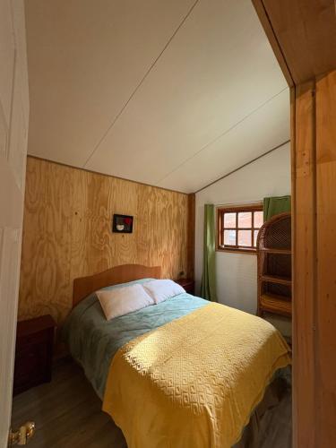 a bedroom with a bed and a window in it at Parcela Peumayen Casa 4 in Pucura
