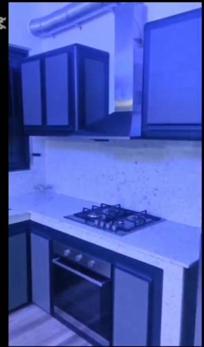 a kitchen with a stove top oven in a kitchen at Ko Villa in Rivière du Rempart
