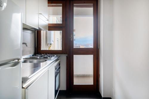 a kitchen with a sink and a stove top oven at Marbela Apartments & Suites in Palermo