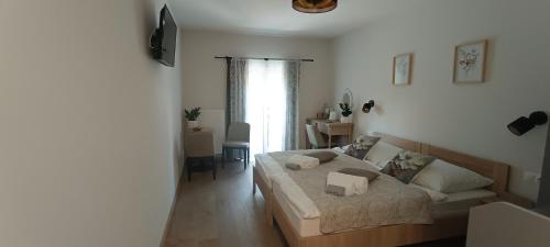 a bedroom with a bed and a couch in it at Pingvin Panzió in Komárom