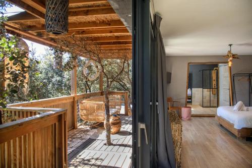 a room with a balcony with a bed and a bedroom at Villa Occitana in Calvisson