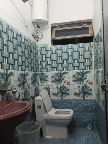 a bathroom with a toilet and a sink at Punchkedar in Phata