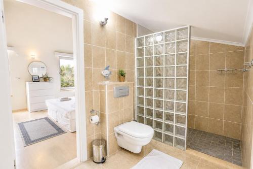 a bathroom with a toilet and a shower at Villa Emilie in Kaş