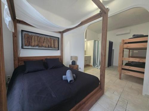 a bedroom with a bed with a blue pillow on it at Cocon des Arènes Nîmes Centre 18 couchages in Nîmes