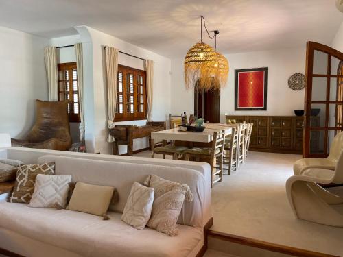 a living room with a couch and a dining room at Authentic Villa with amazing pool in Santa Gertrudis de Fruitera