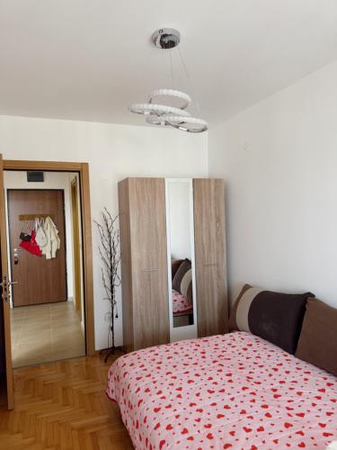 a bedroom with a bed with a red blanket at Sky & Sea View Apartment Budva in Budva