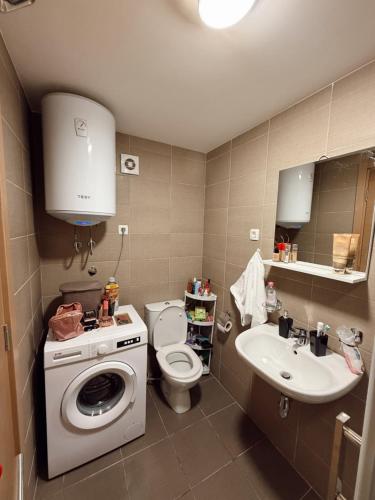 a bathroom with a washing machine and a sink at Sky & Sea View Apartment Budva in Budva