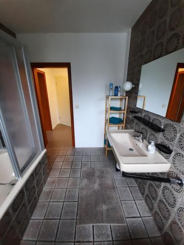 a bathroom with a sink and a mirror at Rikes Ferienwohnung 2 in Heinsberg