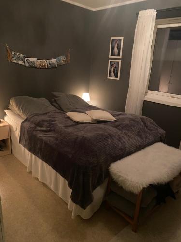 a bedroom with a large bed and a window at Yttermoveien in Narvik