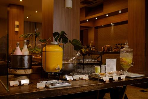 a table in a hotel room with a counter with drinks at Locanda Hotel in Novo Hamburgo