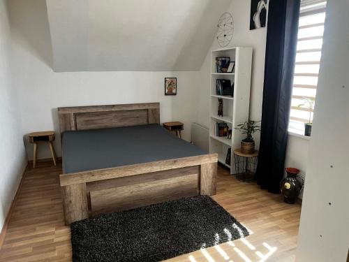 a bedroom with a bed and a book shelf at Útulný dom blízko Košíc in Sokoľany