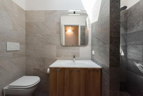 a bathroom with a sink and a toilet and a mirror at Vettori Hideaway by MMega in Florence