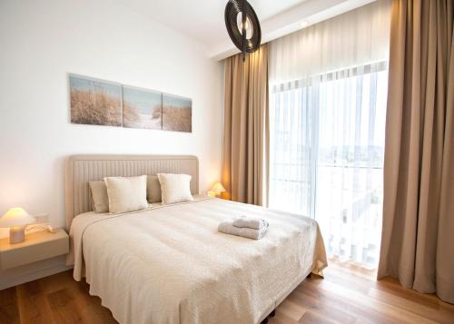 a bedroom with a large bed and a large window at Aqualina C2-4 by HolidayKeys in Kyrenia